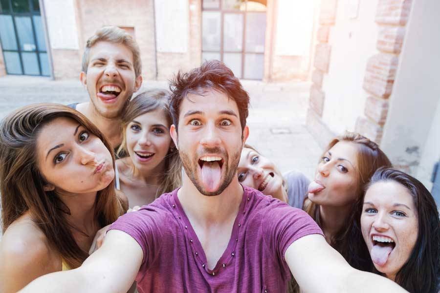 Group of friends taking a selfie making silly faces