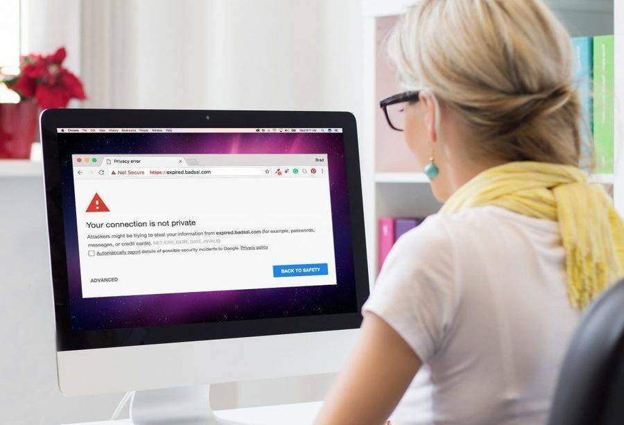 woman looking at SSL not secure certificate on desktop