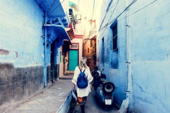 woman walks down alley while traveling