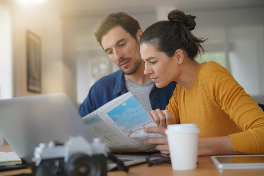 Couple looking at maps to plan a trip