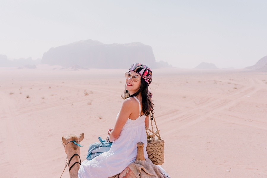 woman riding on camel back