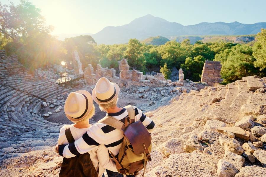 Senior tourism: older couple exploring ancient Greek ruins