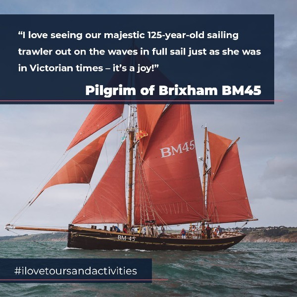 Sailing trawler on water with quote