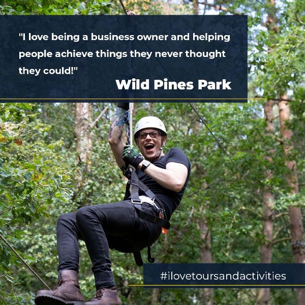 Man going down zipline with quote