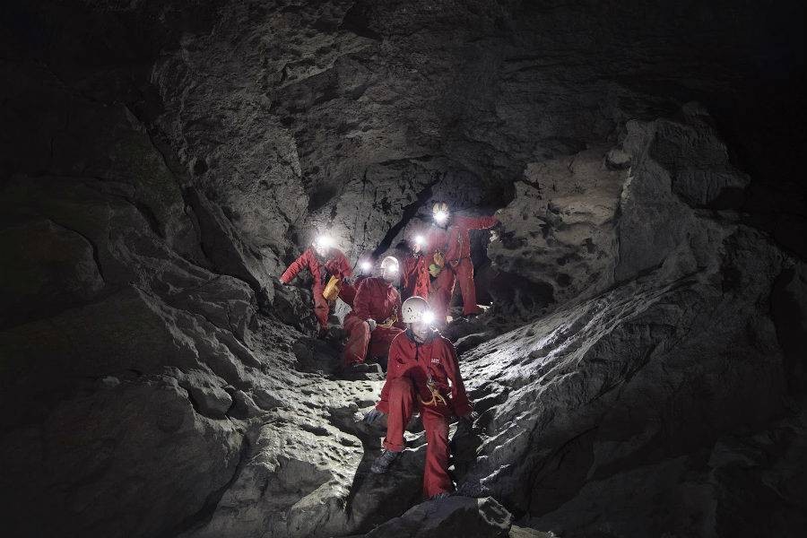 Guests exploring a cave with Canmore Cave Tours after making an online booking.
