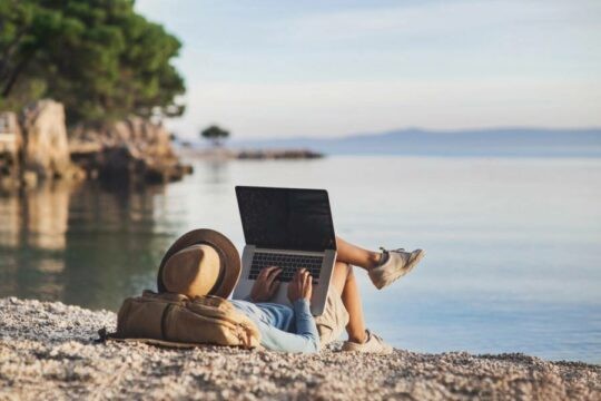 Using a laptop on the beach