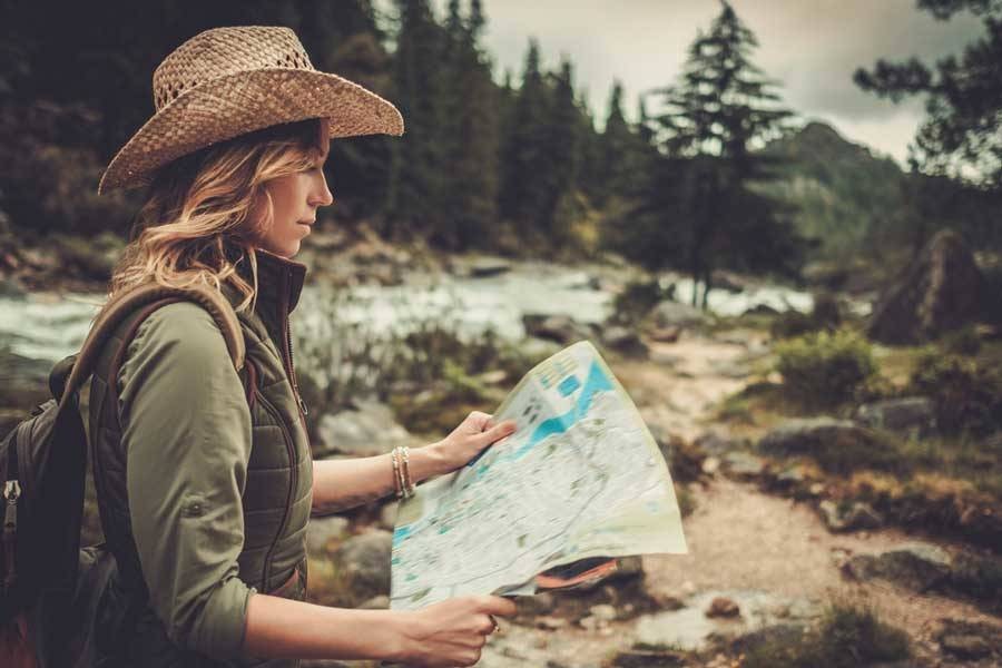 Girl using a map while hiking