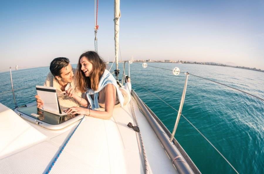 People using a laptop on a yacht