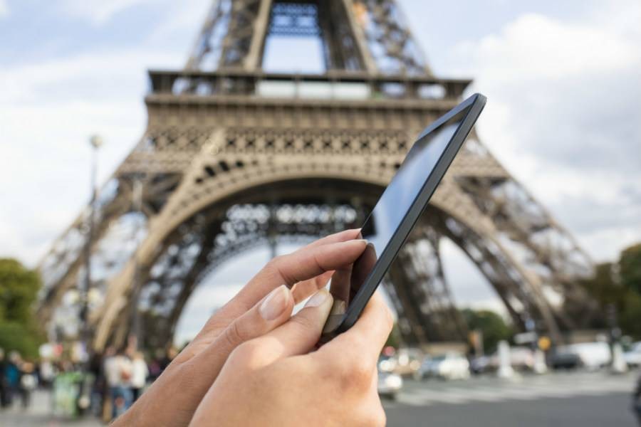 Using phone in front of Eiffel Tower