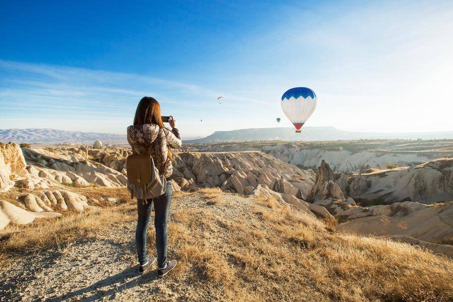 Woman taking photo of air balloon