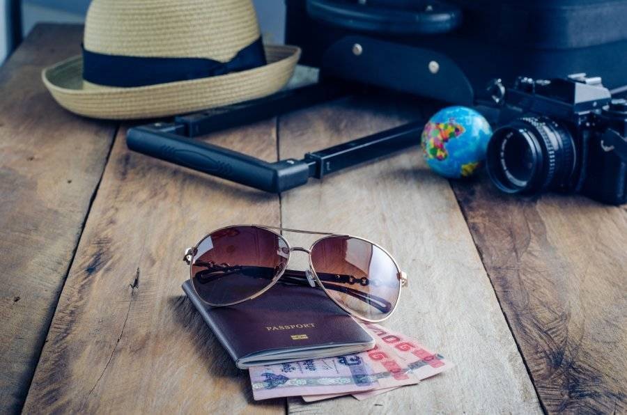 sun glasses and passport on desk