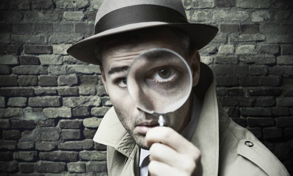 A detective looking through a magnifying glass