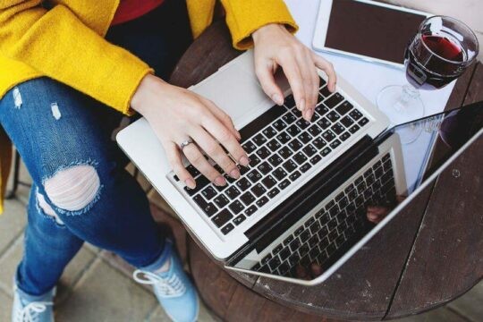 Close up of woman's hands on laptop keyboard