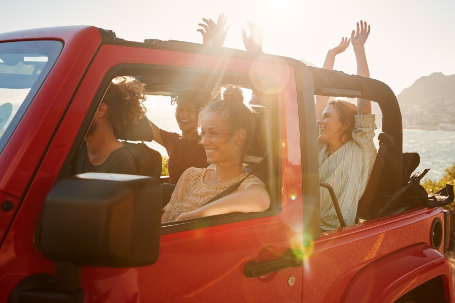 Group of women sitting in a jeep