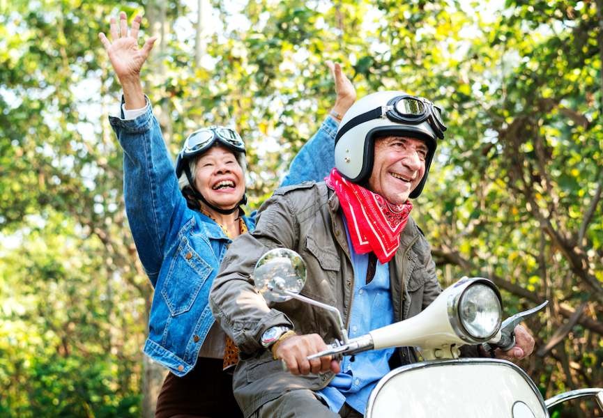Man and woman riding moped