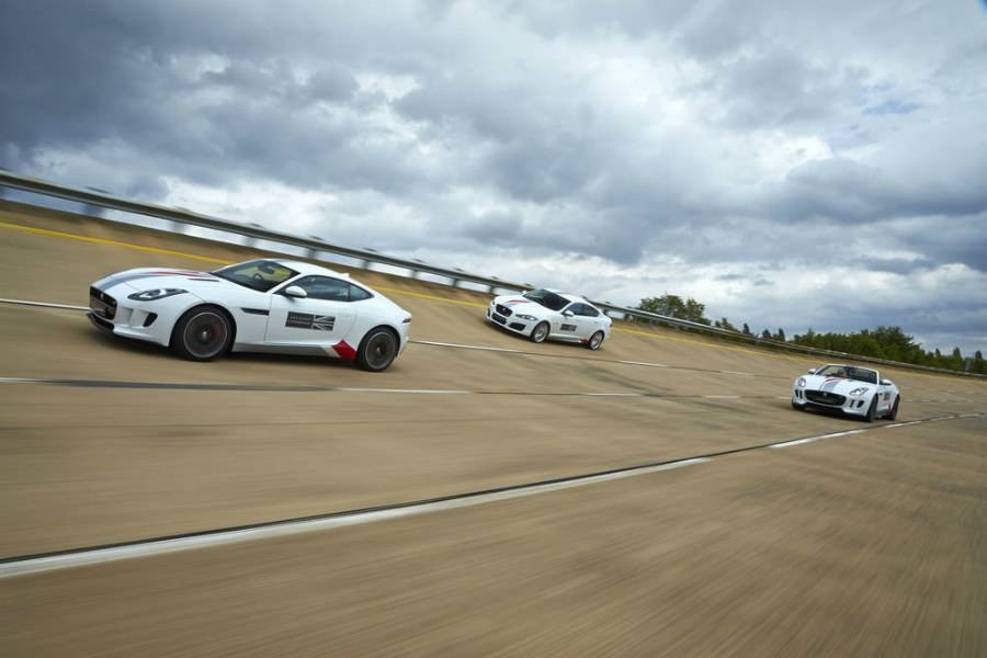 Three white Jaguars racing on race track