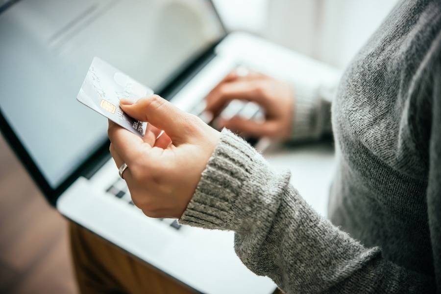 Person using a credit card to pay online