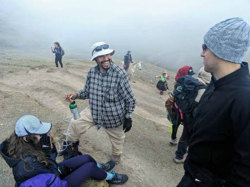 Rainbow Mountain Expeditions tour guide giving guest oxygen on hike.