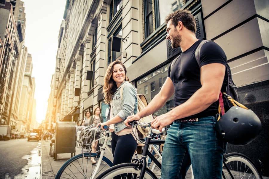  A female and male traveler on bikes on a New York City street