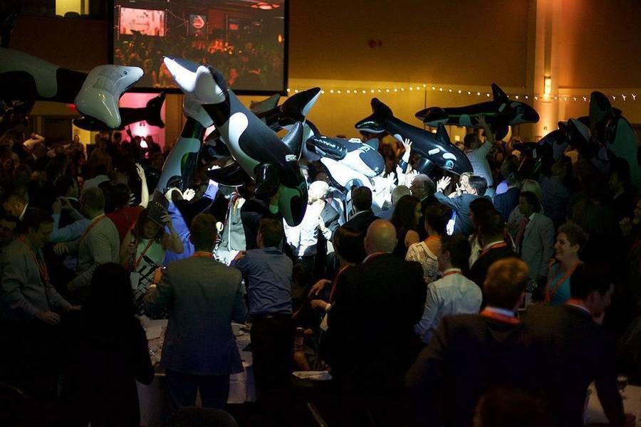 Attendees at Viatec awards throwing blow up orcas into the crowd