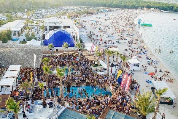 Aerial view of ZRCE beach party and the travelers who booked on mobile