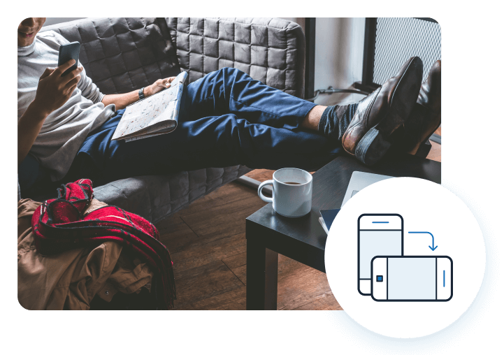 man using devices on couch and responsive icon