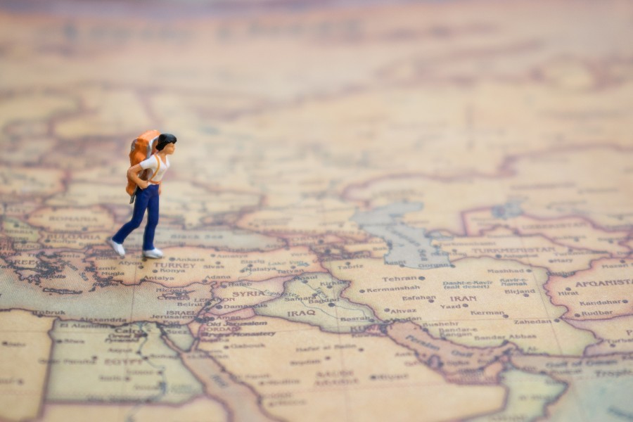 tour guide rules with a miniature travel figure on map