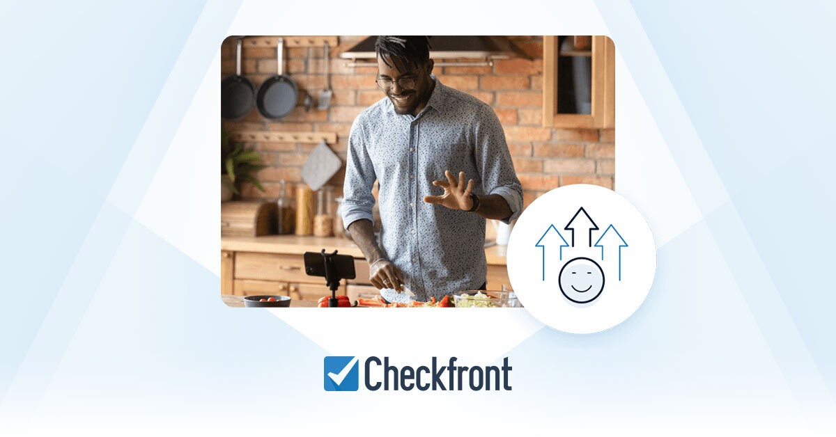 Photo of man cooking in front of phone, on top of light blue and white background and Checkfront logo beneath photo.