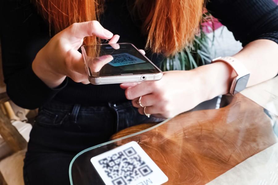 Person scanning QR code using phone