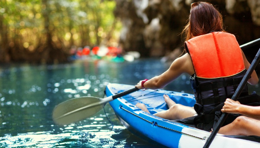 woman kayaking with family